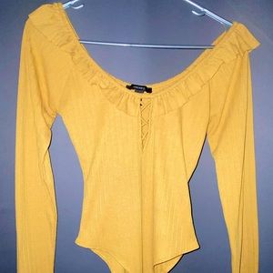Tight yellow onesie from Forever 21. For women comfortable showing off chest.